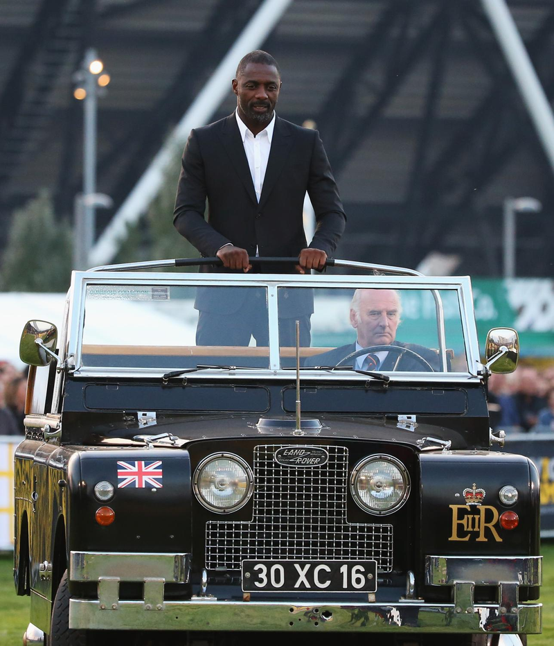 Illustration for article titled Here's Idris Elba Riding A Land Rover Like It's A Preppy War Chariot